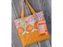 Why not show off those large personality prints in your stash with this straightforward tote. Simple lines mean the fabric does the hard work for you. A coordinating zip pouch with swivel hook and D ring completes the ensemble. Hang it from the outside or tuck it inside the tote. Either way, you can keep the necessities handy and look great doing it.