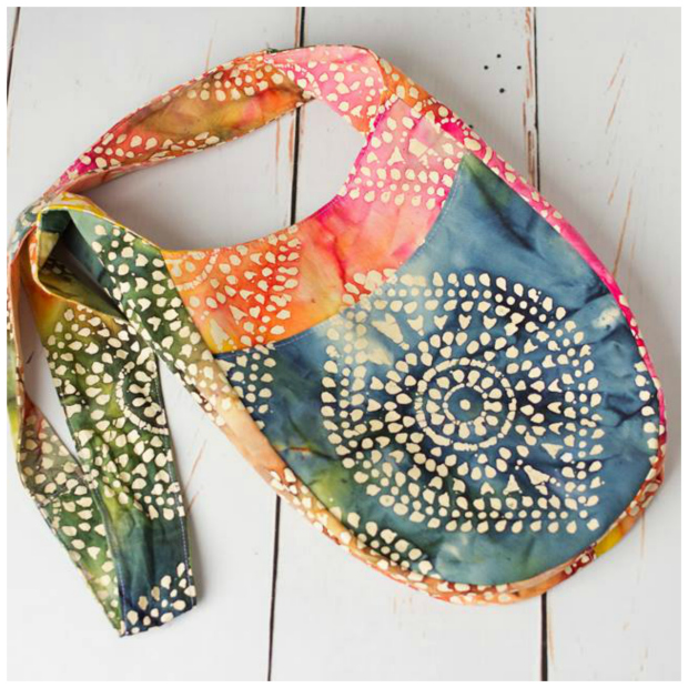 India’s crossbody boho vibe appeals to the flower child in all of us. Tie a knot in the long strap to wear it as a shoulder bag. Two open pockets and two zippered pockets will keep everything organized. And it’s even reversible so be sure to choose a lining fabric wisely. Two size options included.