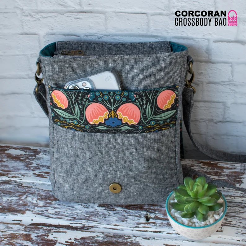 Corcoran Crossbody Bag sewing pattern (with videos). This messenger style crossbody bag is ideal as an every day bag to take to work or the office. So many great pockets inside and out, great fashion and style, and lots of space for everything you need. Video sewalong tutorial included with this crossbody bag sewing pattern. SewModernBags
