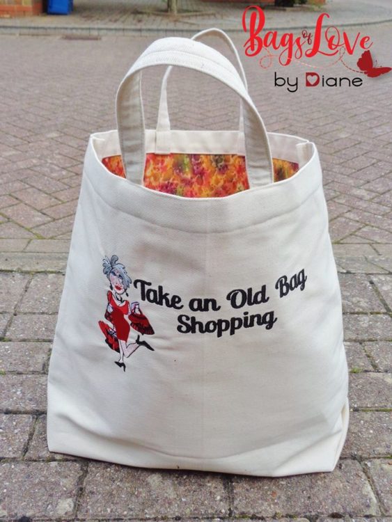 Front view of free tote bag pattern sitting on a brick road
