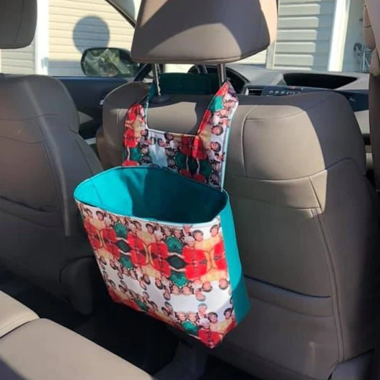 Trash can bag hanging over seat in car